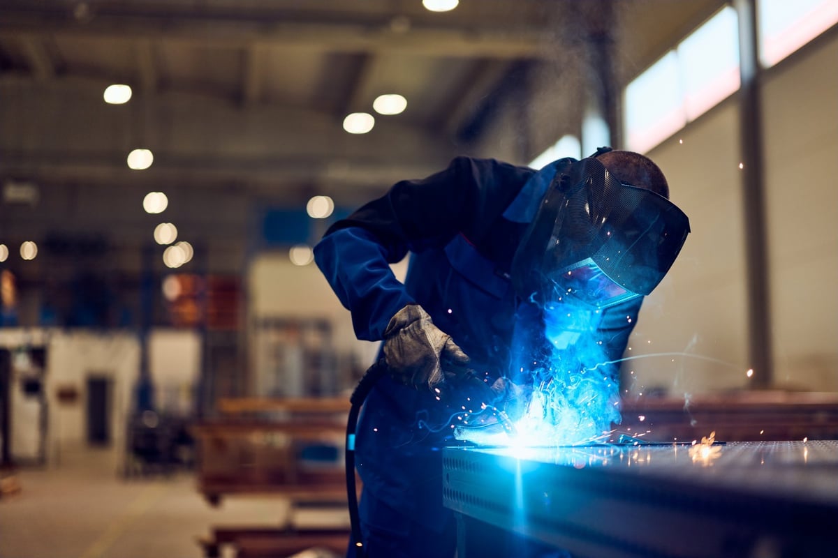 Professional welder working with sparks